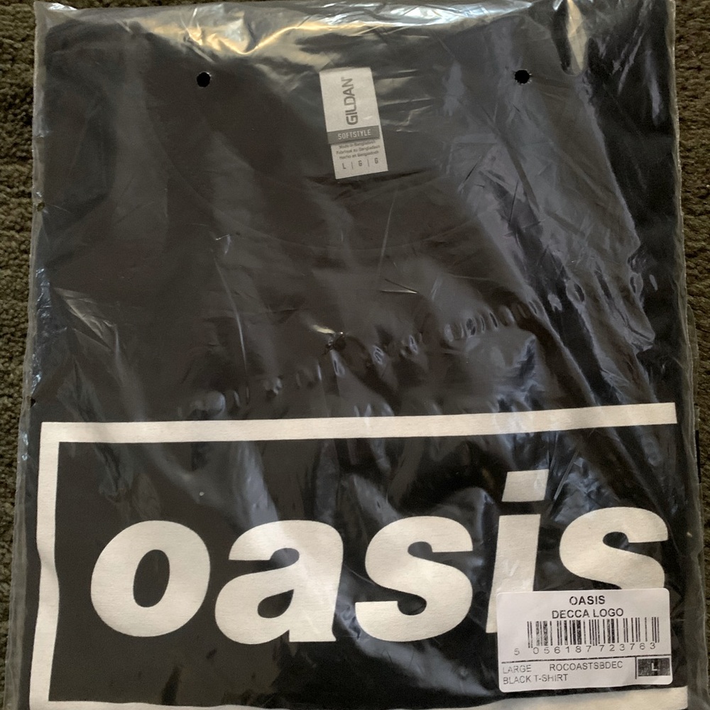Black T-shirt size L, with white “oasis” band logo. Brand new, still in bag.